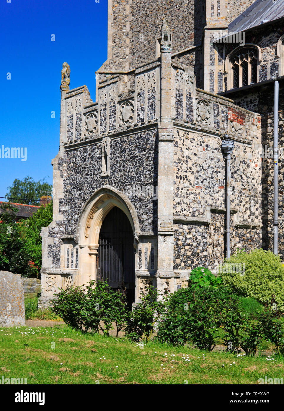 A view of the south porch of the parish Church of St Martin at New Buckenham, Norfolk, England, United Kingdom. Stock Photo