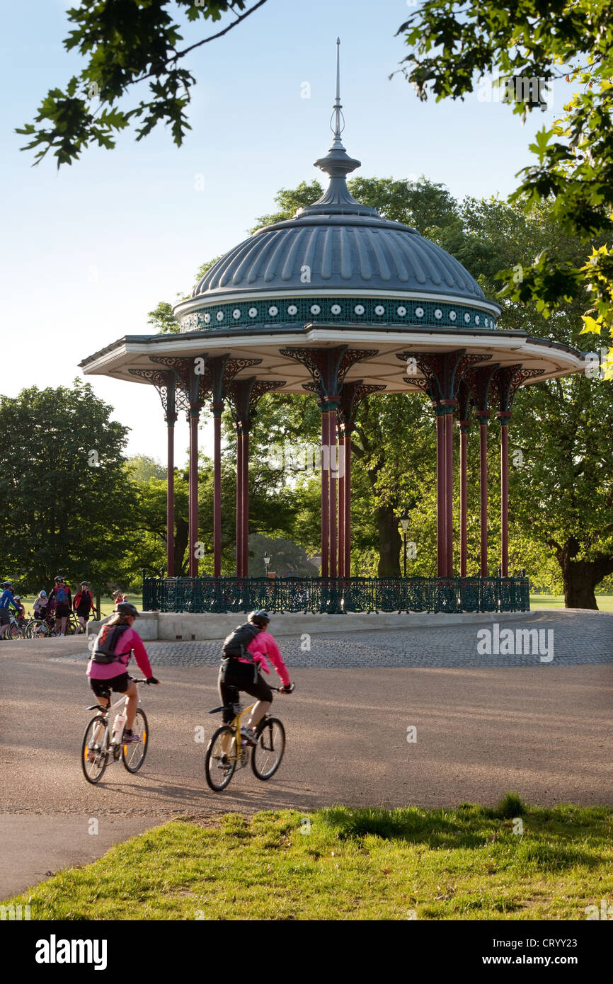 Riders cycling by the bandstand, Clapham Common; the charity London to Brighton cycle ride, UK Stock Photo