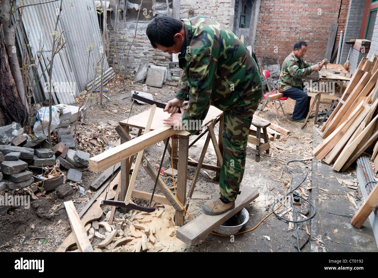 craftsmen working on renovation of traditional old courtyard house in Beijing China Stock Photo