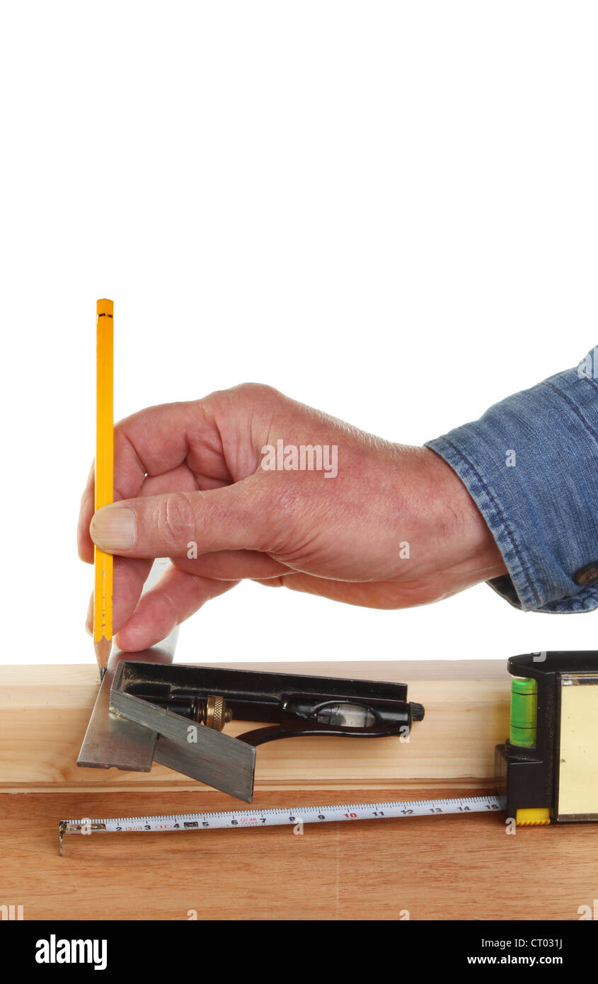 Closeup of a hand measuring and marking wood Stock Photo