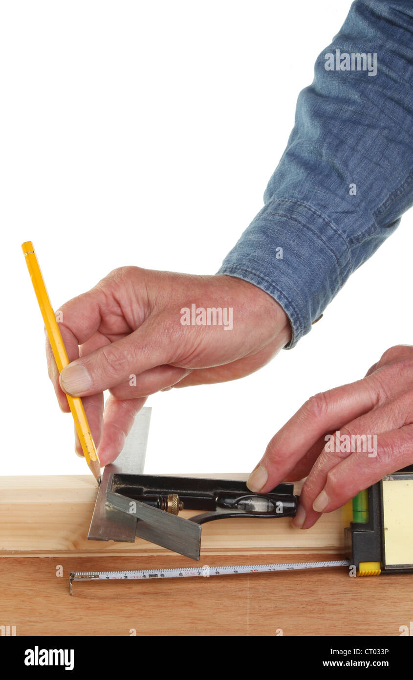 Closeup of a pair of hands measuring and marking wood Stock Photo