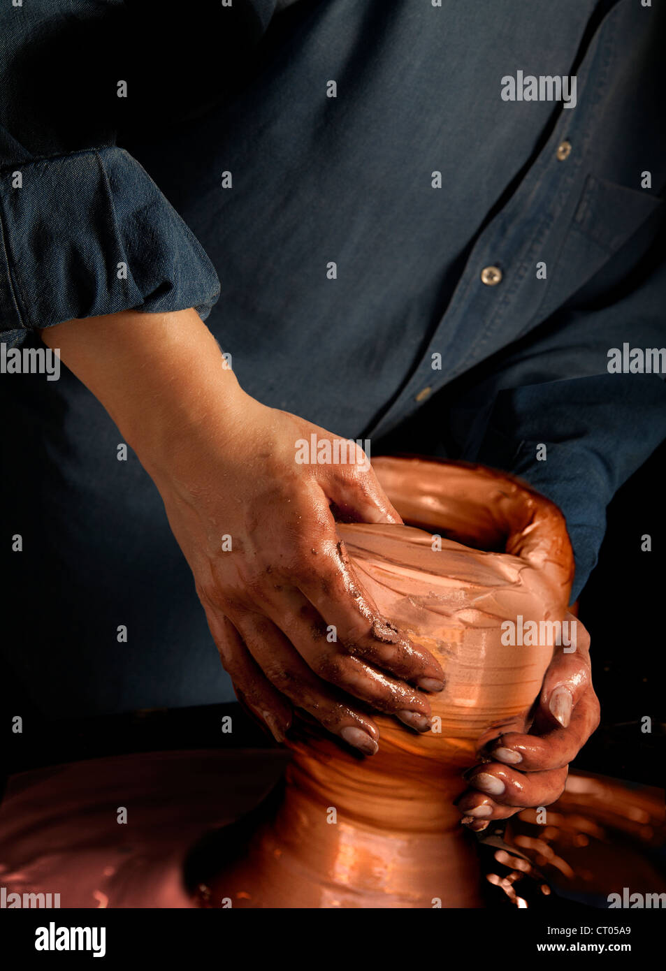 Female hands at Potter's wheel Stock Photo