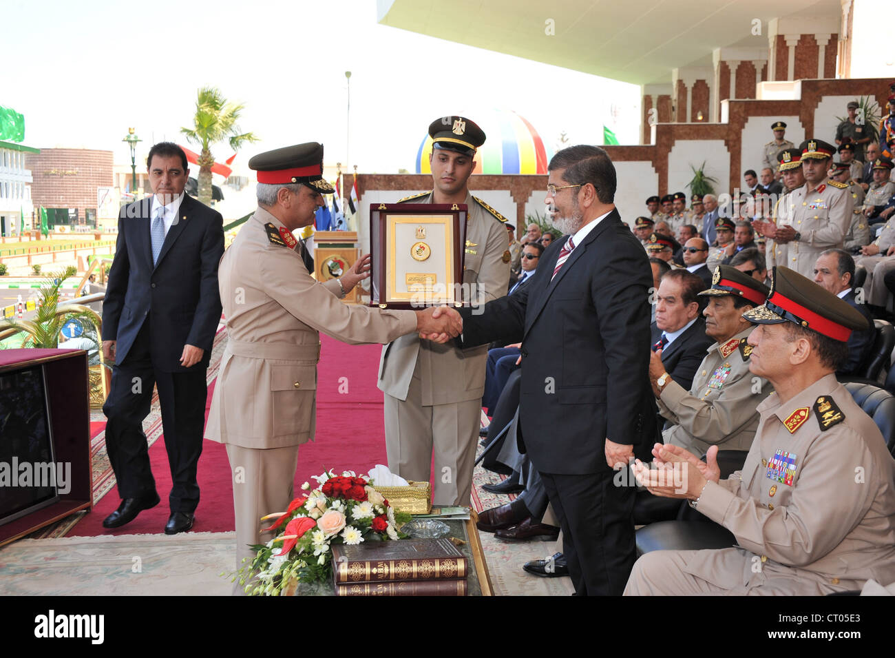 Egypt's President Morsi attends Civil Aviation graduation cermonies with Military head Hussein Tantawi and other senior figures. Stock Photo