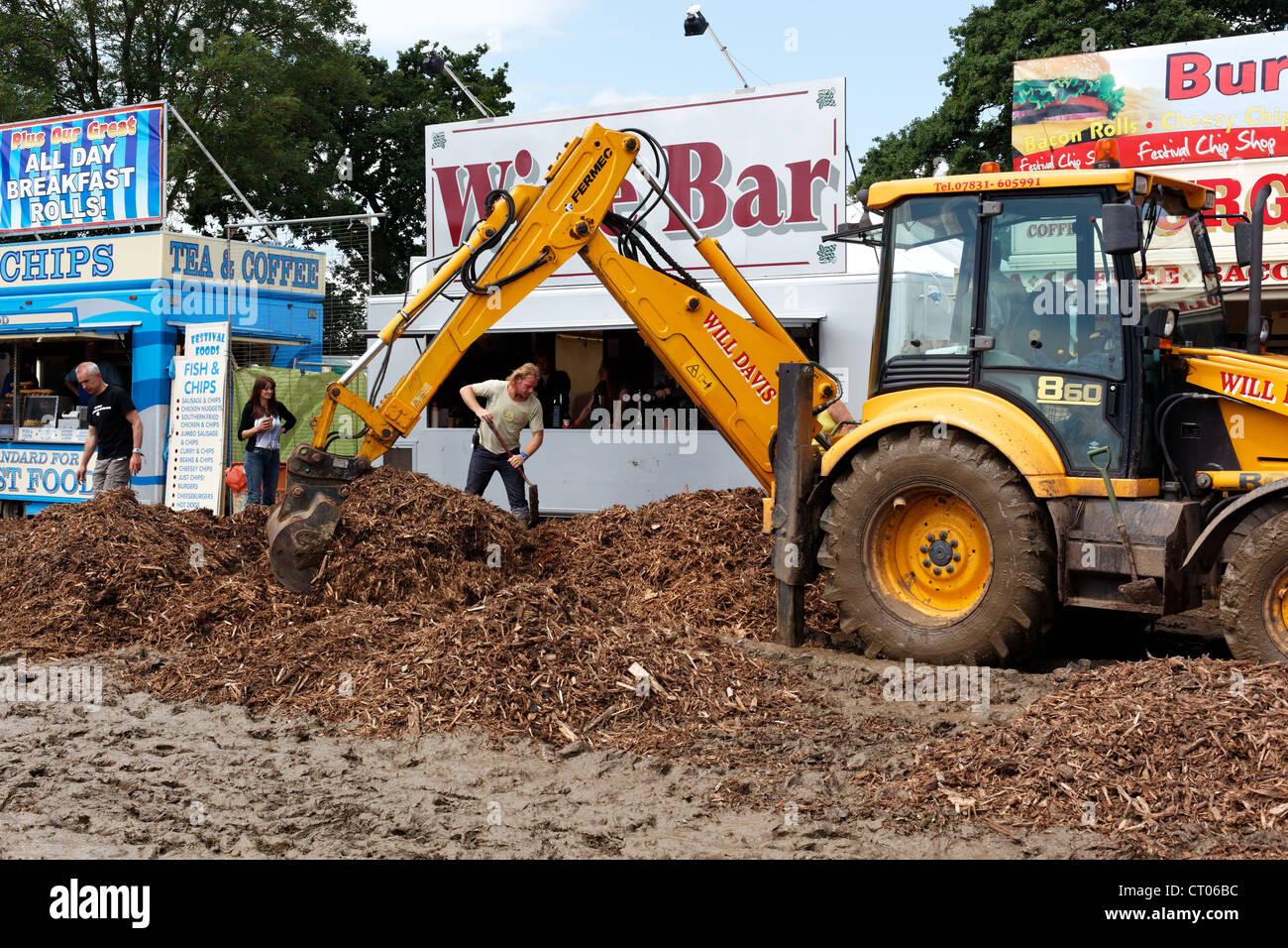 Following further heavy rainfall staff at the Glastonbury Festival spread wood chips to help dry the site. Stock Photo