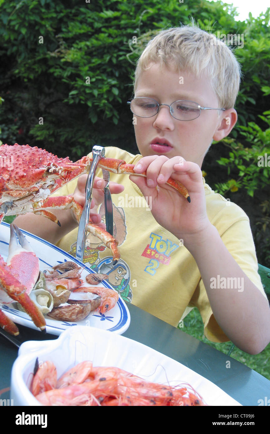 CHILD EATING FISH Stock Photo Alamy