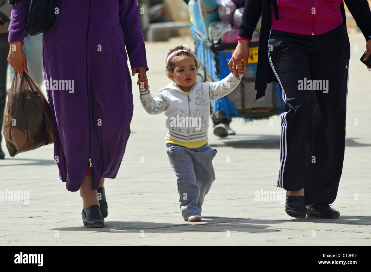 Child holding hands and walking in Fes, Morocco Stock Photo Alamy