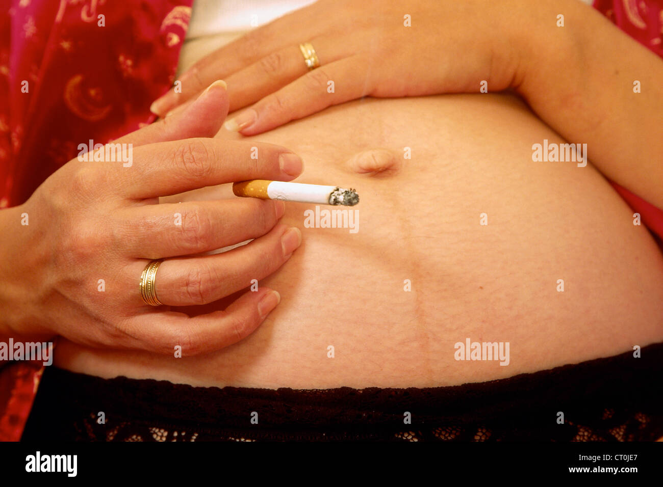 PREGNANT WOMAN SMOKING Stock Photo