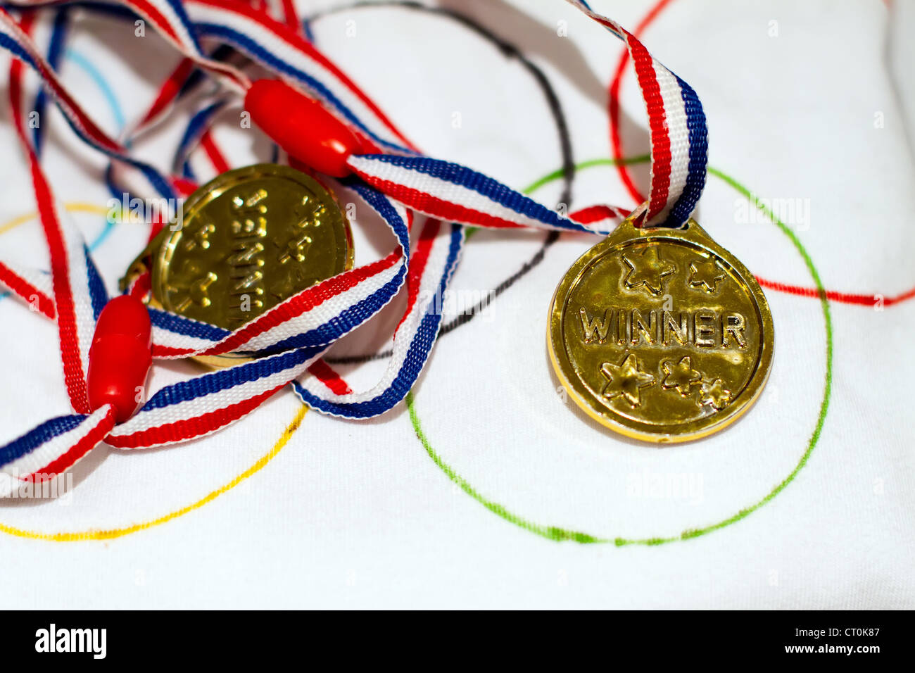 gold winners medal on an Olympic t shirt Stock Photo