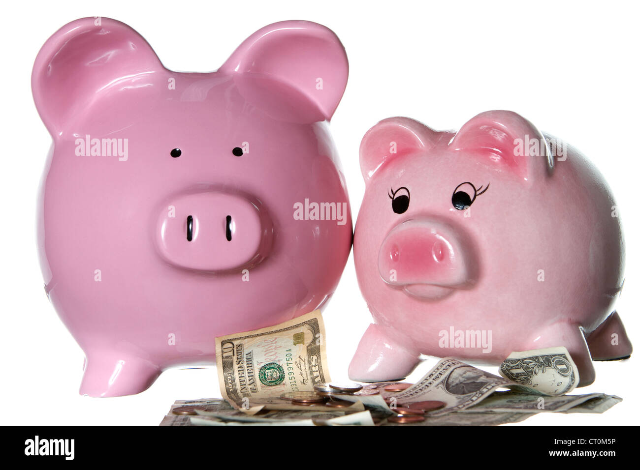 Pink Piggy bank with dollar bills and coins Stock Photo