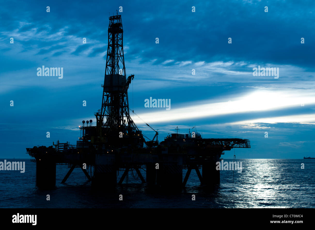 silhouette of an offshore oil drilling rig in low light sunset/sunrise time. Coast of Brazil Stock Photo