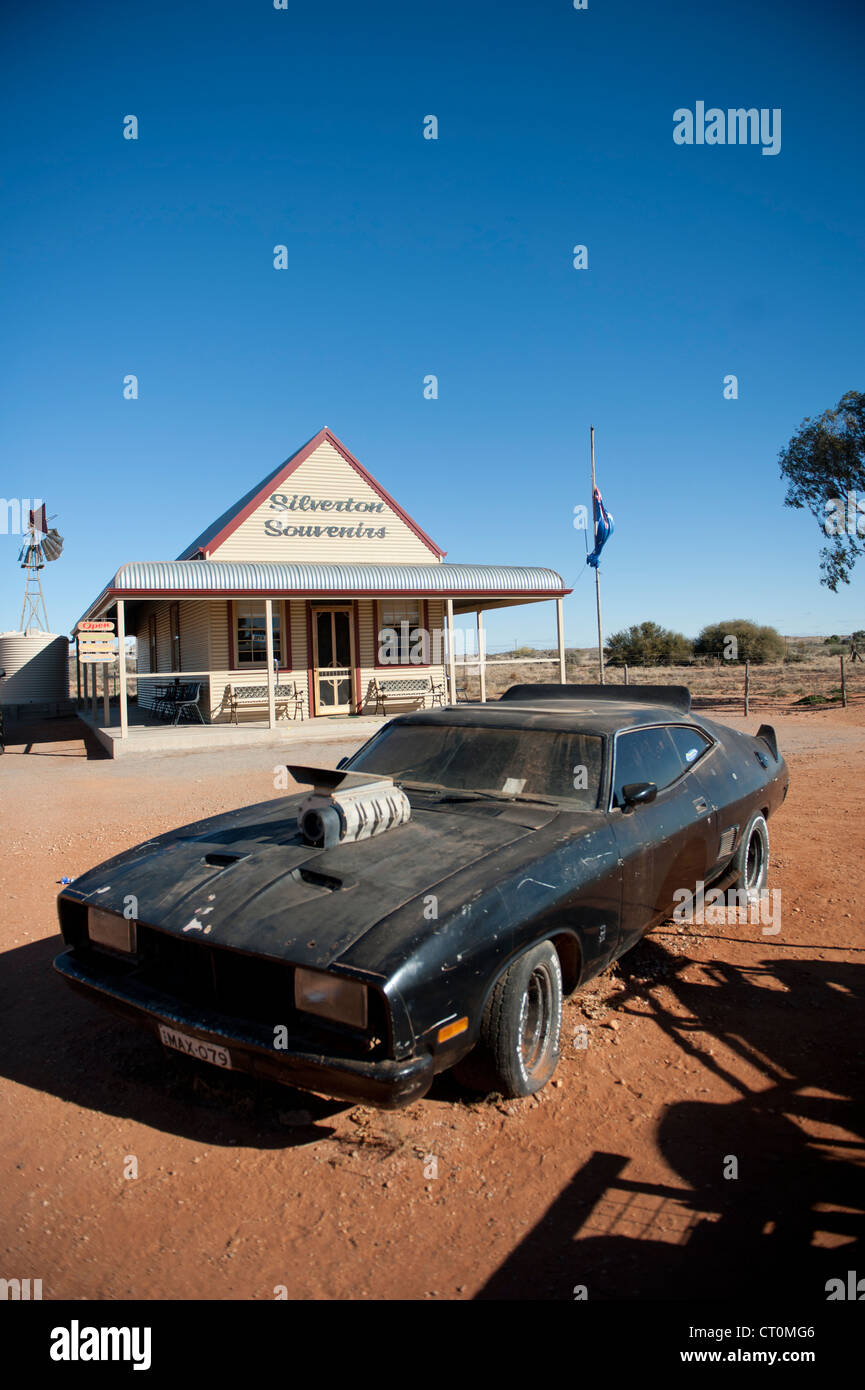 The film car of Mad Max 2 parked in front of an old homestead now shop in Silverton, outback New South Wales Stock Photo