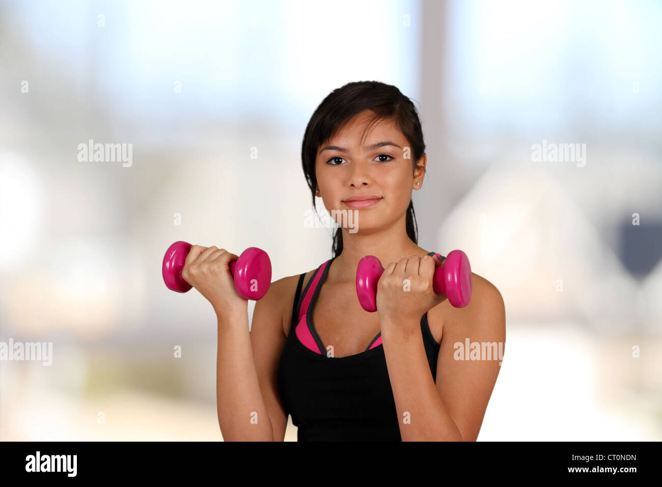 Teen girl working out in the gym Stock Photo
