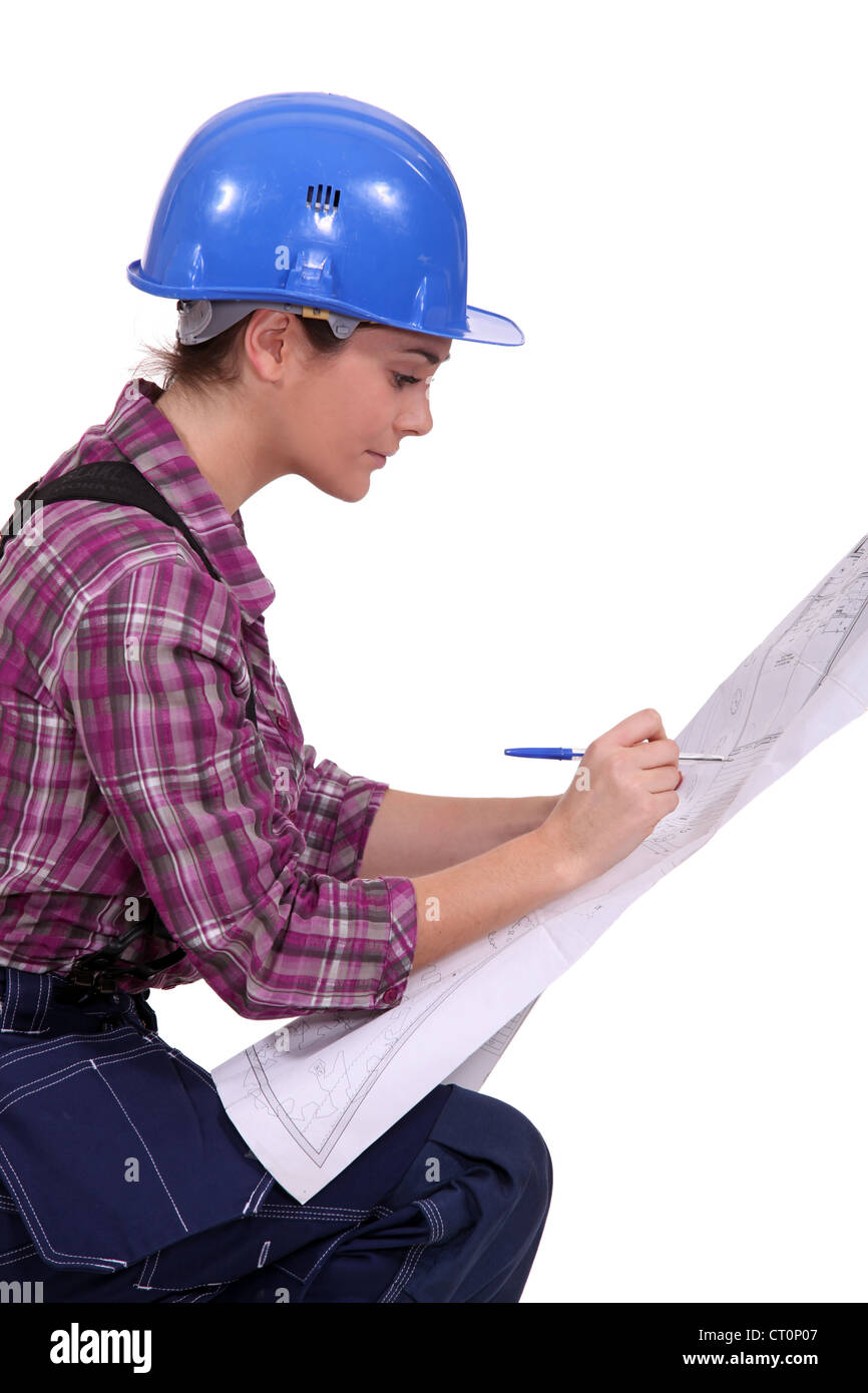 female architect in profile with blueprints Stock Photo