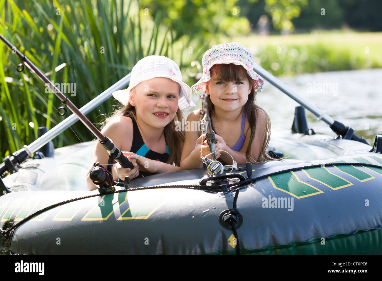 little girls fishing on lake at summer Stock Photo Alamy