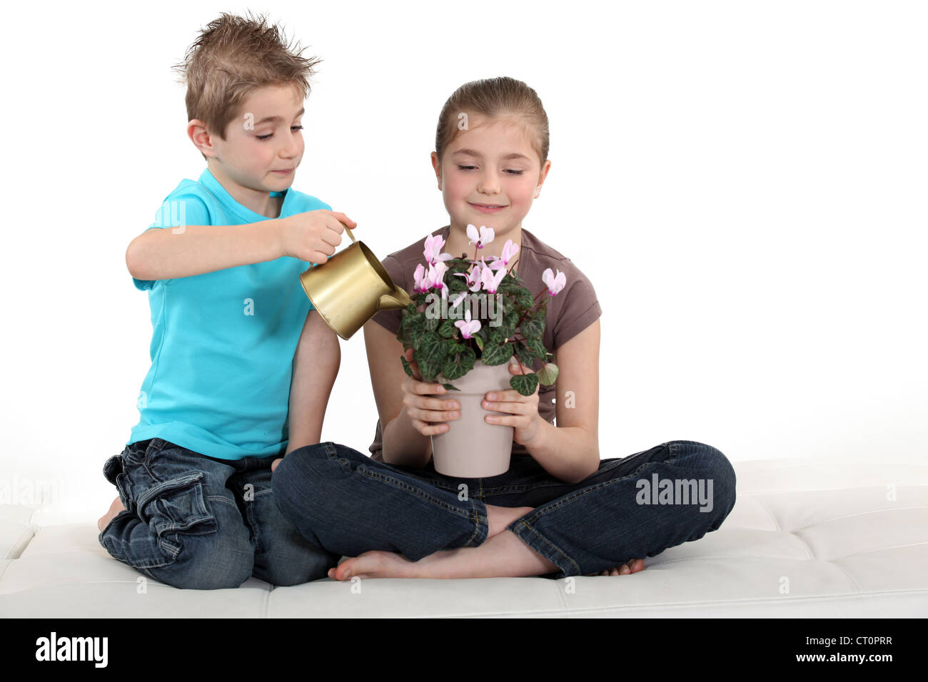 Girl and boy watering plants hi-res stock photography and images - Alamy