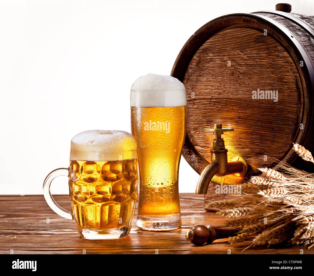 Beer barrel with beer glasses on a wooden table. Isolated on a white background. Stock Photo