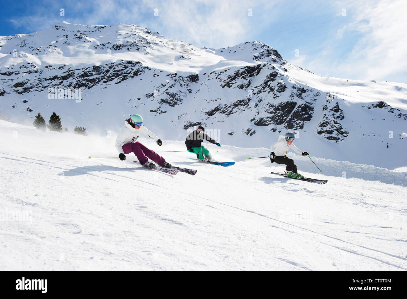 Skiers skiing together on slope Stock Photo