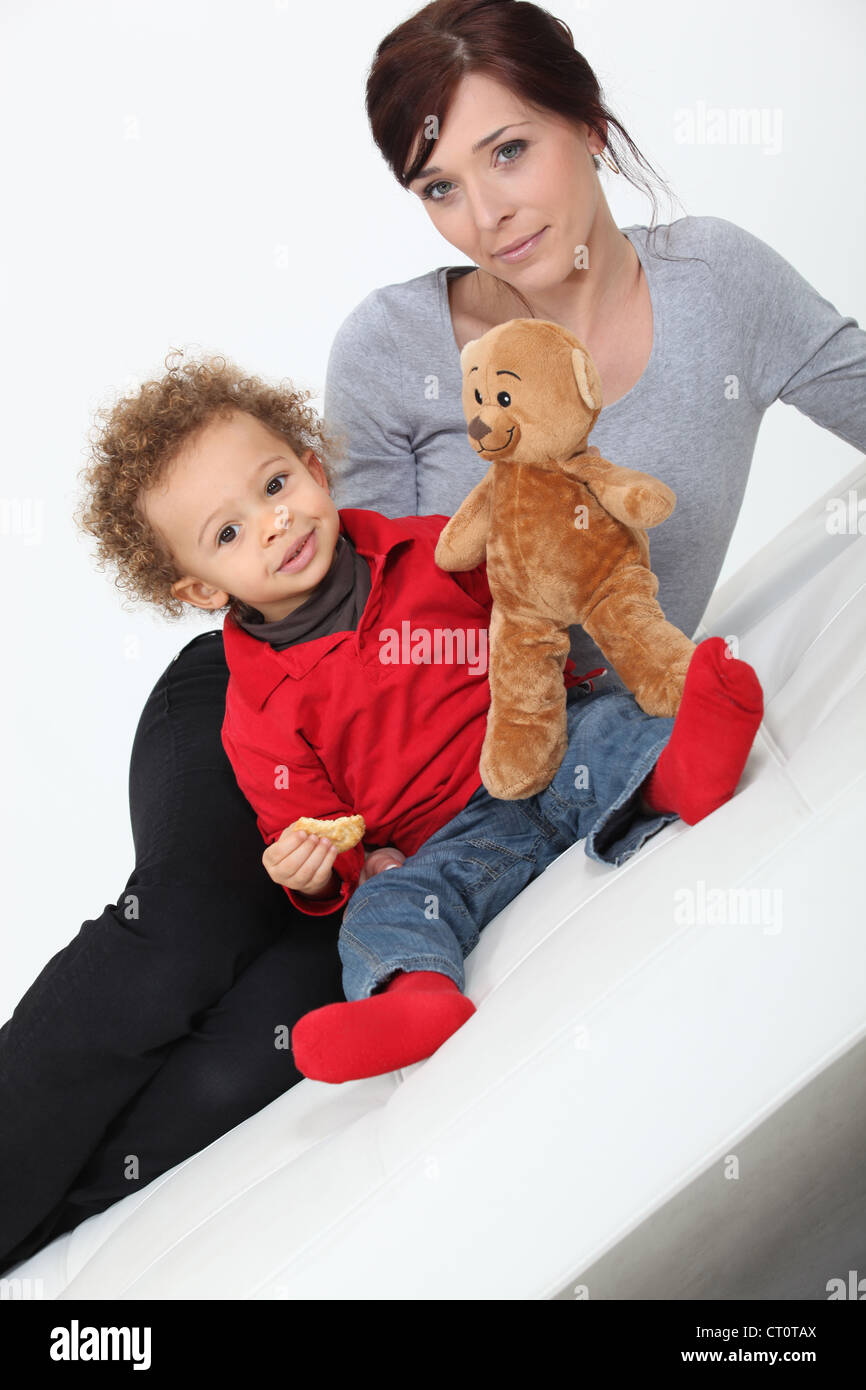 Mother and child posing with a teddy bear Stock Photo - Alamy