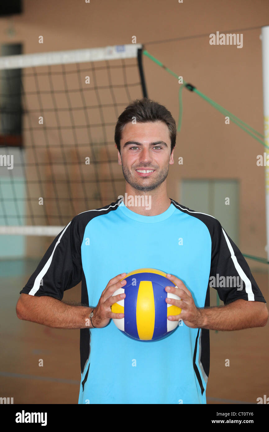 Volleyball player with ball in front of net Stock Photo Alamy