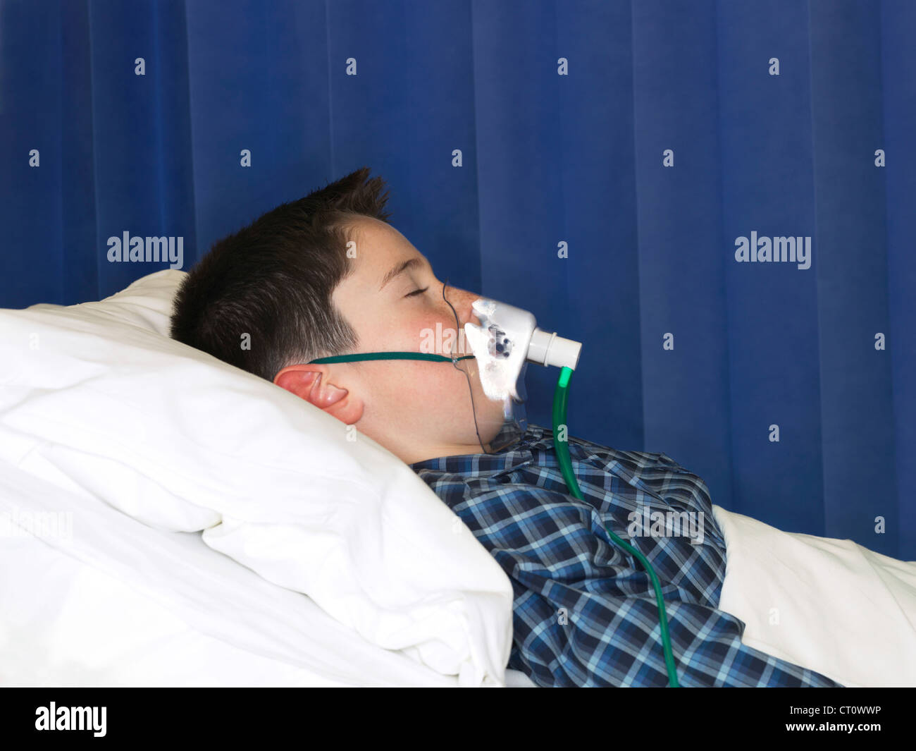Boy wearing oxygen mask in hospital Stock Photo