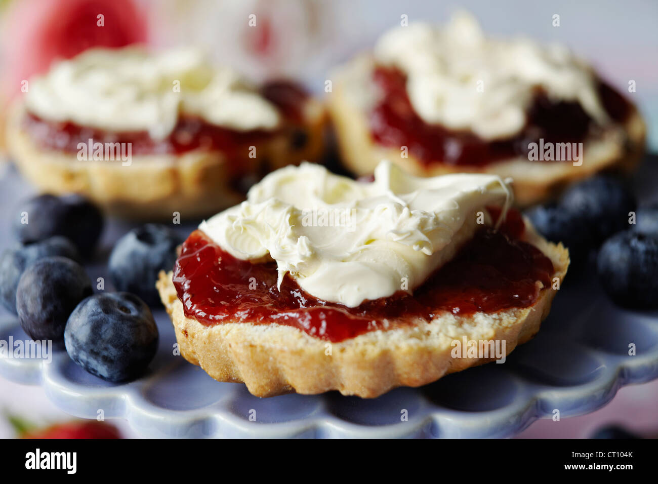Close up of sliced scone with jam Stock Photo