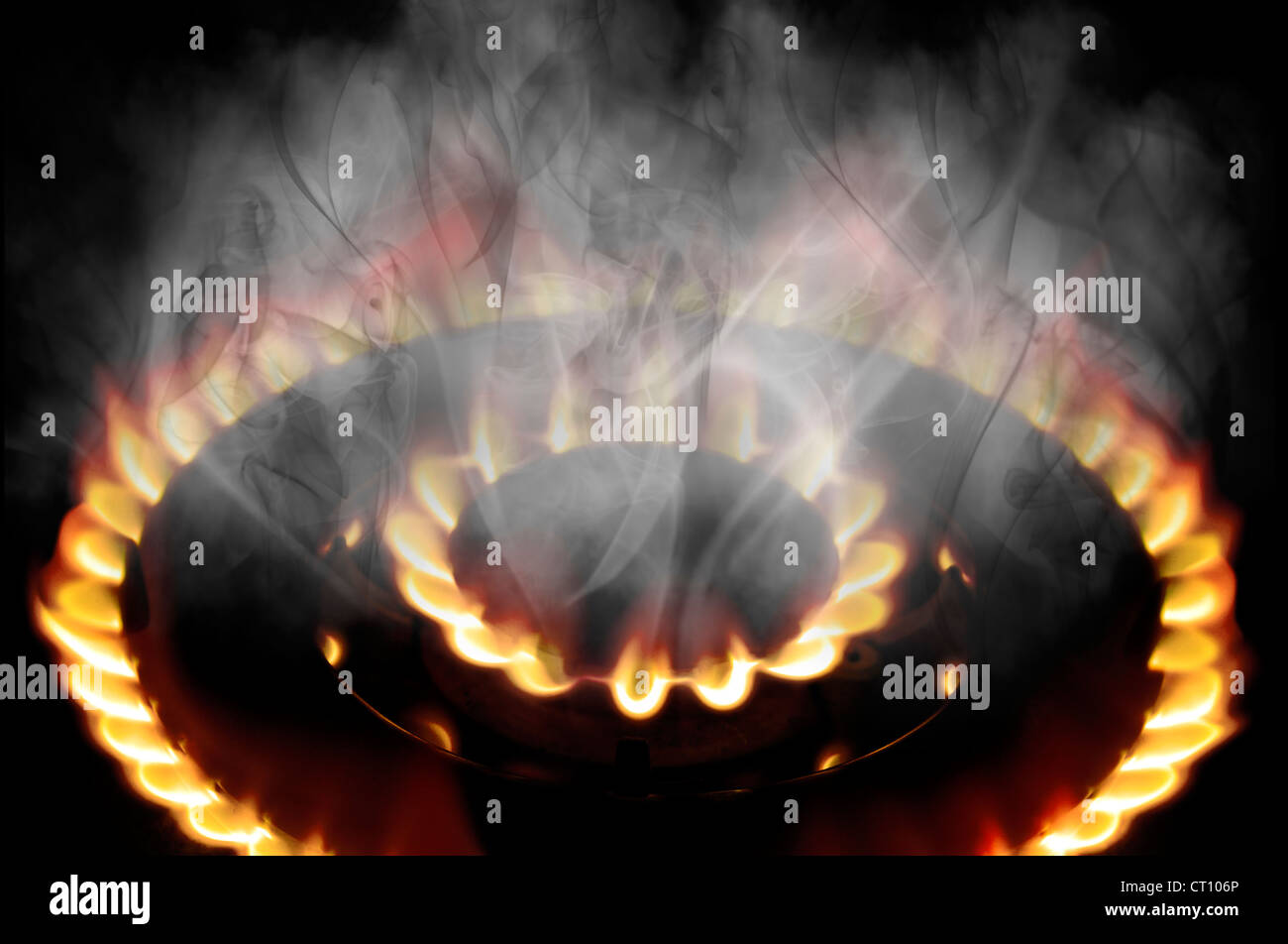 Dangerous Orange and Red Smoking Flame from a gas cooker on a black