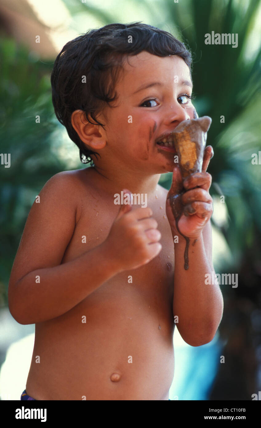 CHILD EATING SWEETS Stock Photo