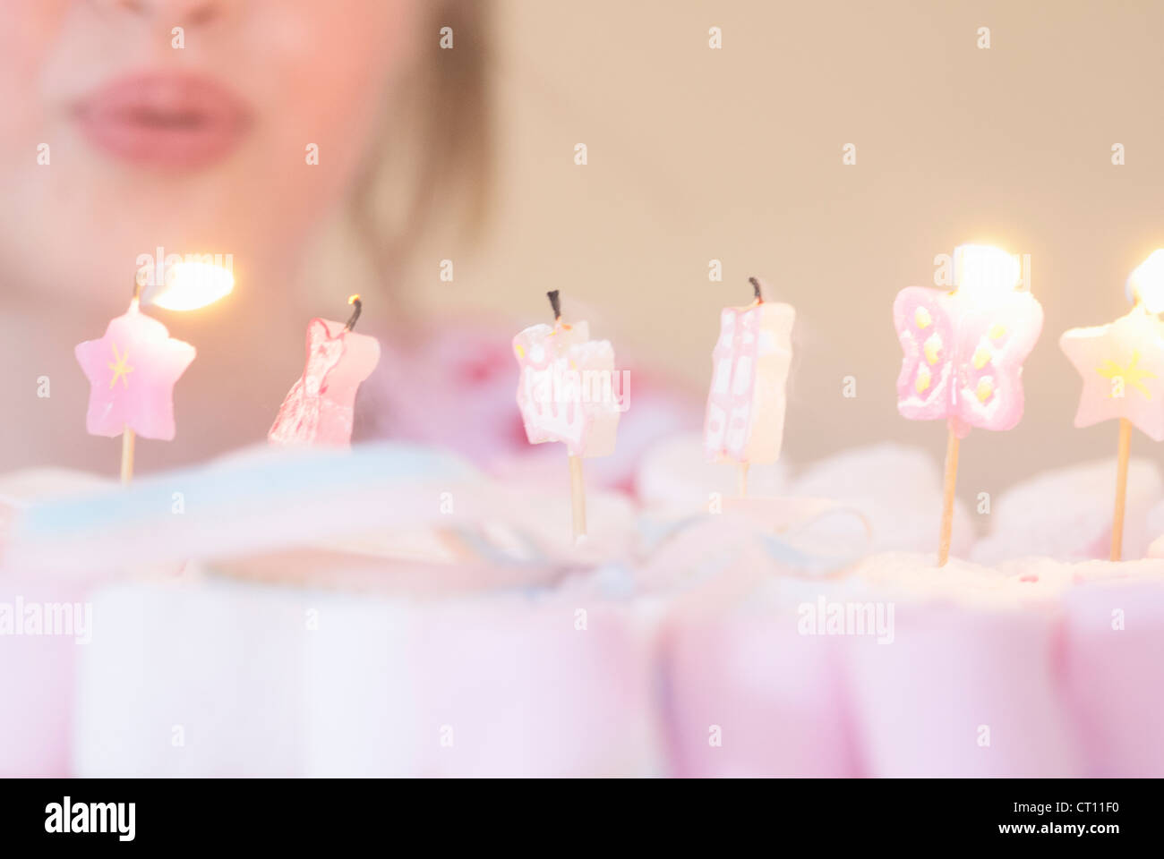 Girl blowing out candles on candies Stock Photo Alamy