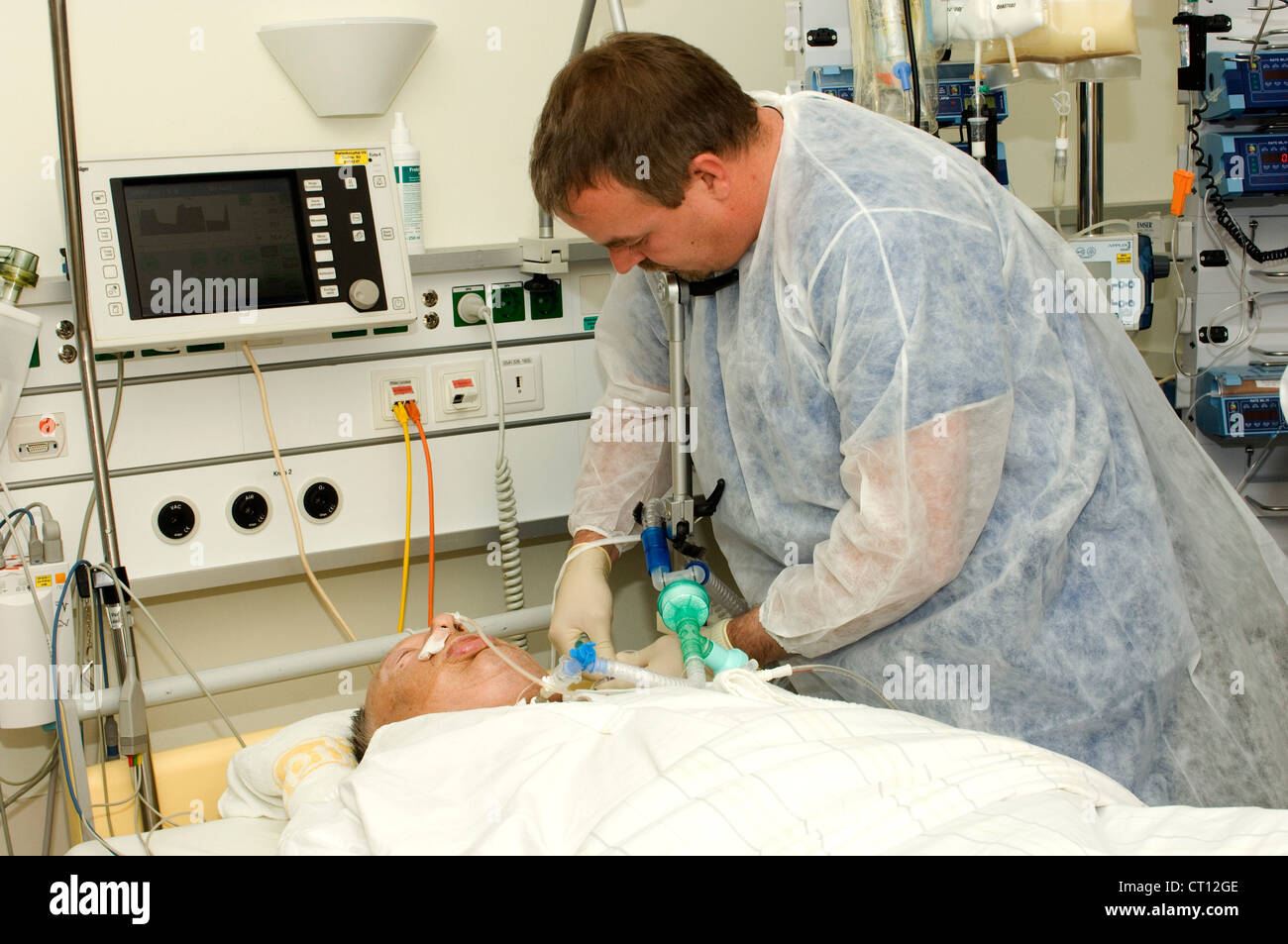 A surgeon checking a patient during an endoscopic procedure. Stock Photo