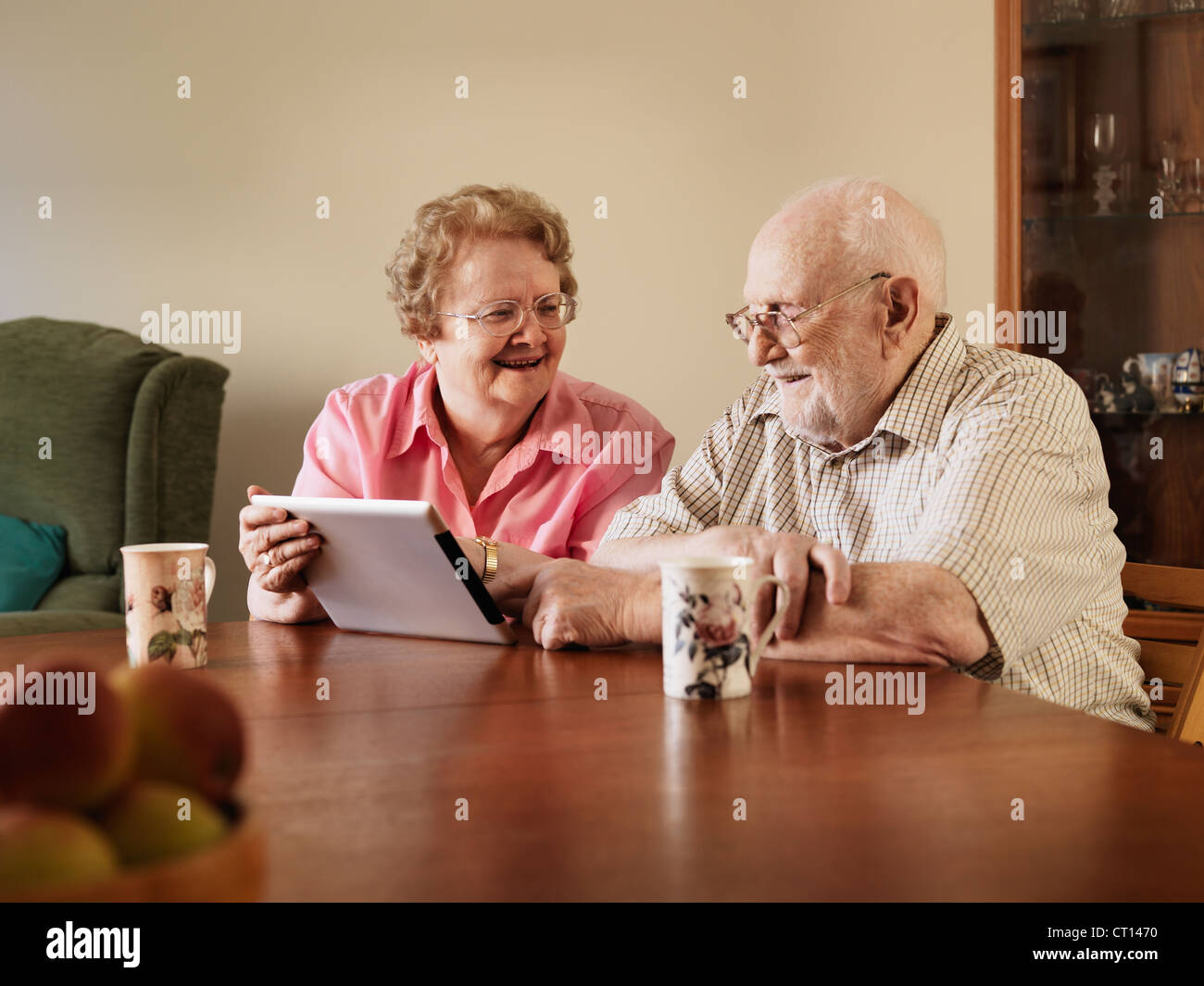 Older couple using tablet computer Stock Photo