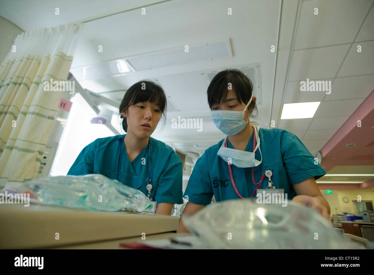 Two nurses are collecting equipment needed on the intensive care unit for the day. Stock Photo