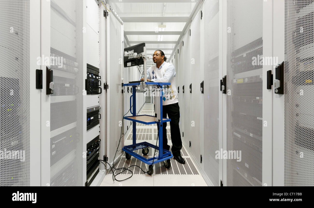 Businessman using computer with servers Stock Photo