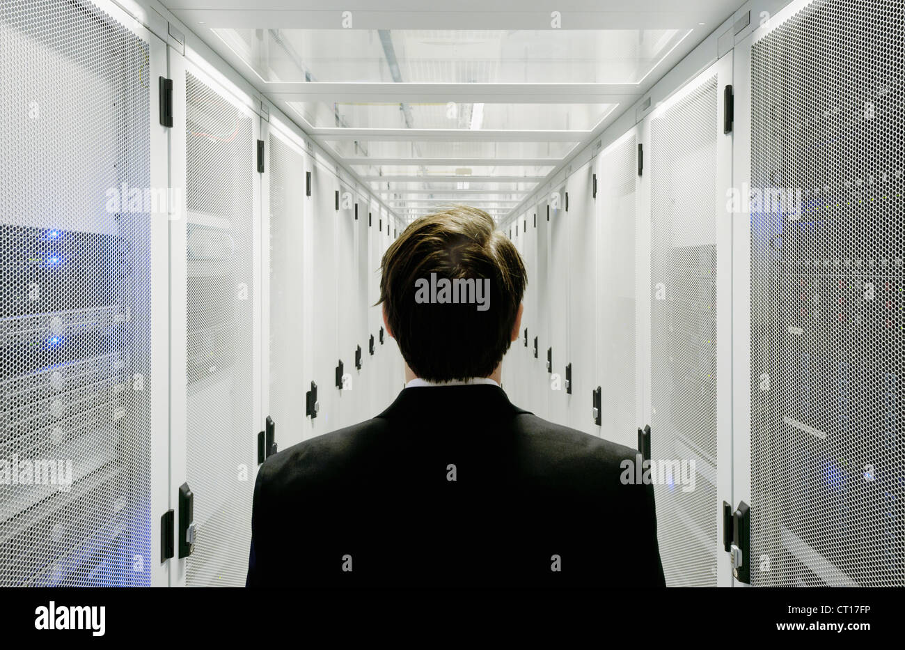 Businessman walking in server room Stock Photo