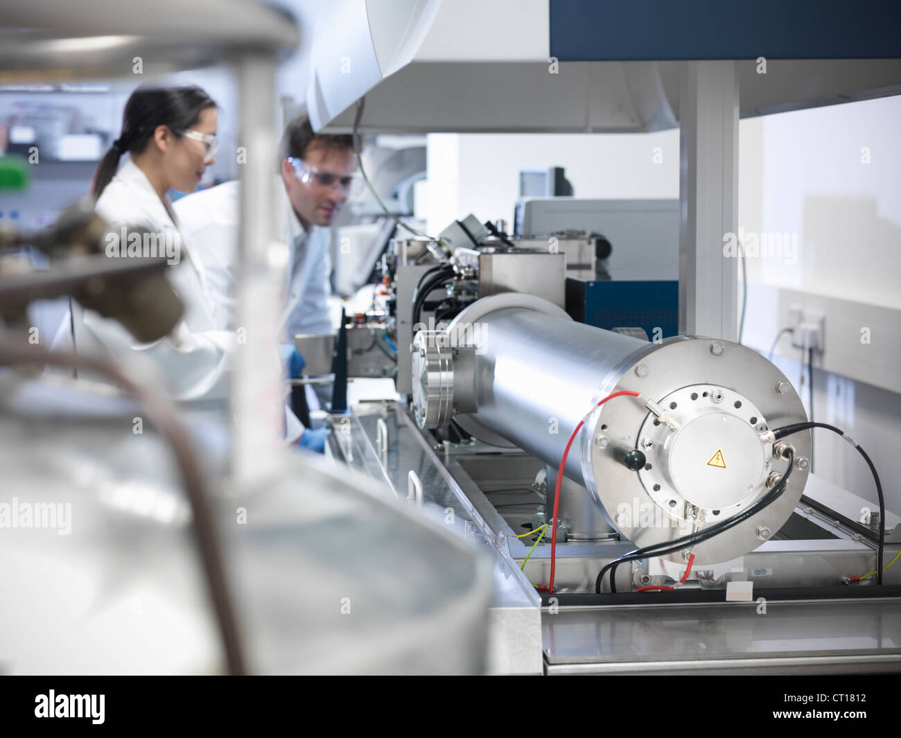 Scientist using equipment in lab Stock Photo