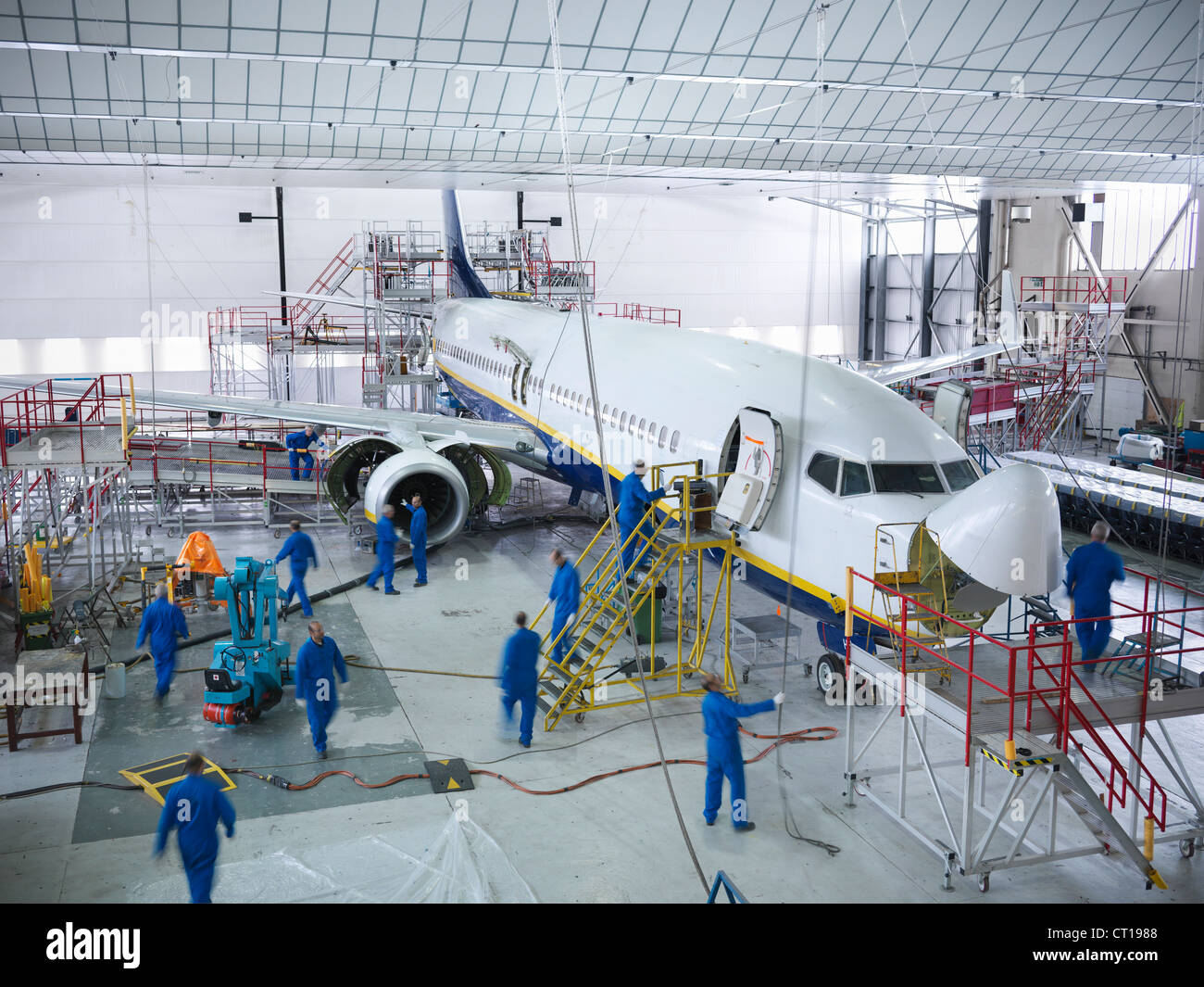 Workers in airplane hangar Stock Photo