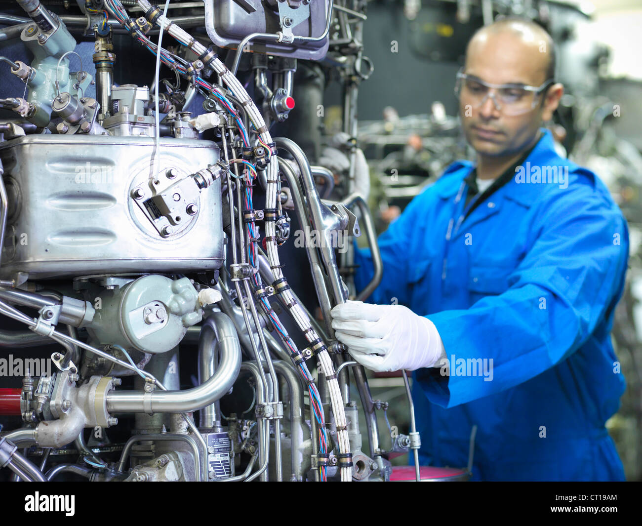 Worker examining machinery on drums Stock Photo