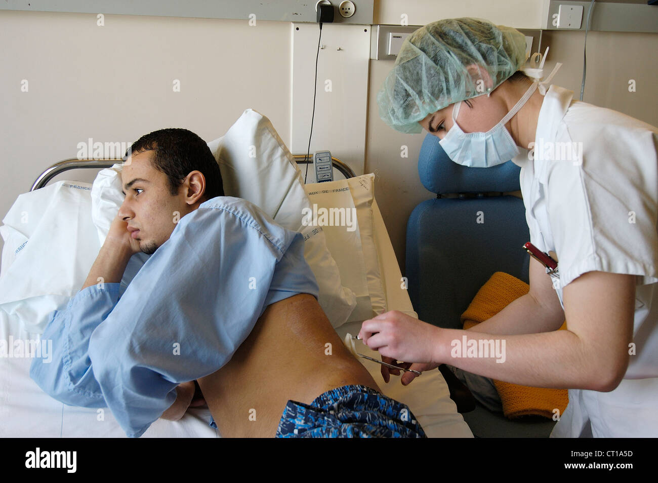 MAN HOSPITAL PATIENT W. NURSE Stock Photo