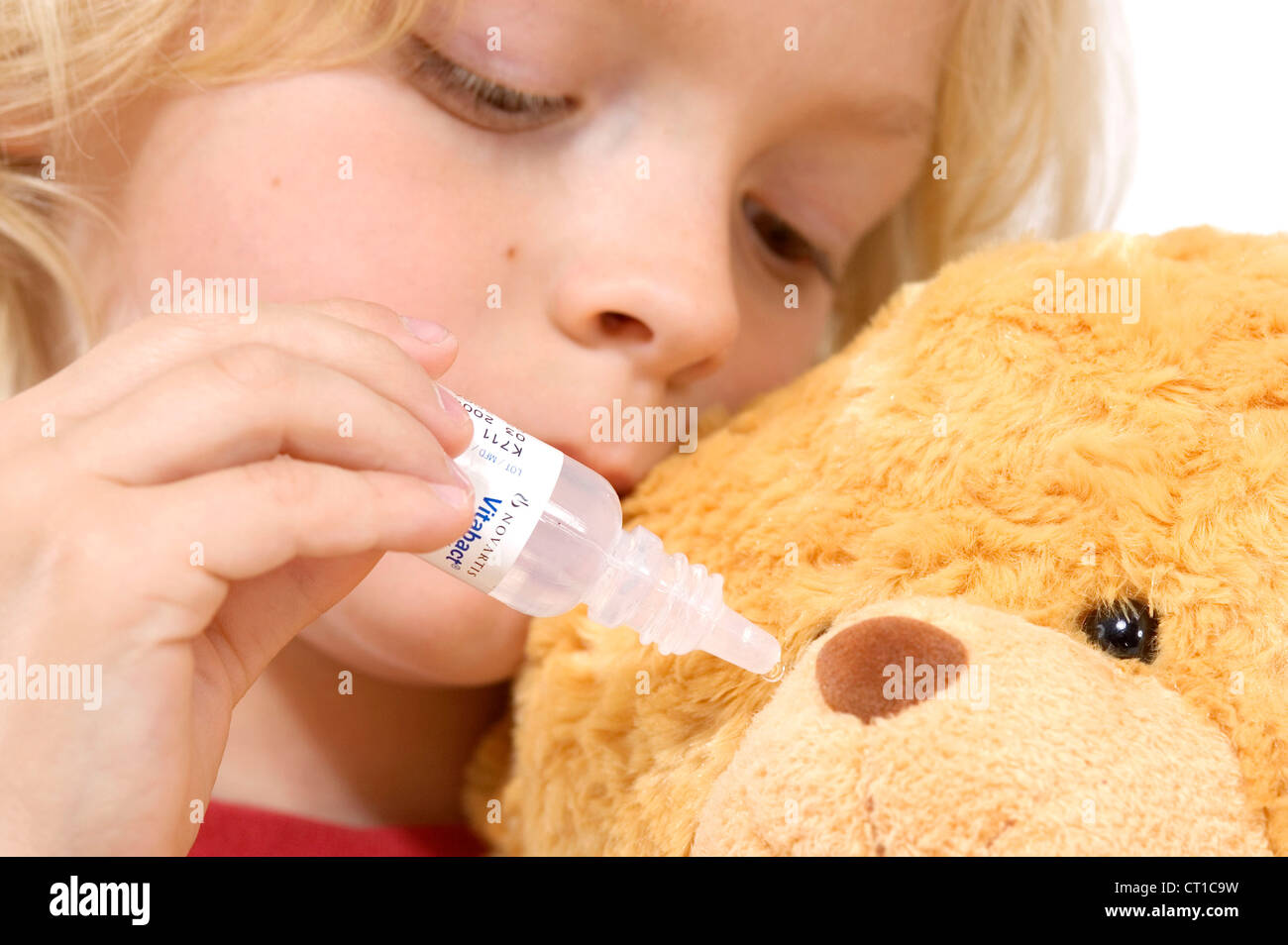 CHILD USING EYE LOTION Stock Photo Alamy