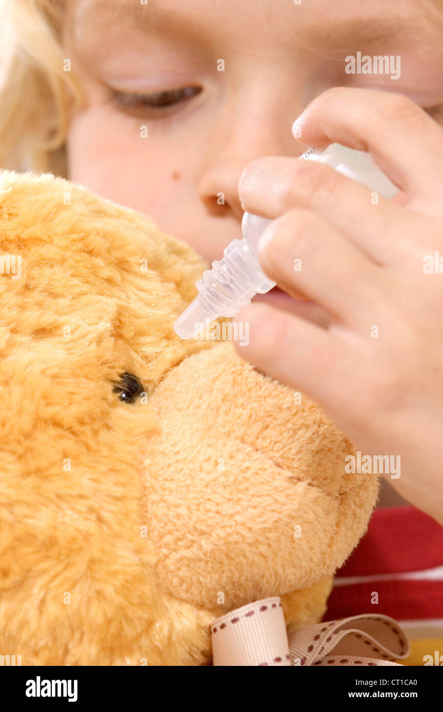 CHILD USING EYE LOTION Stock Photo Alamy