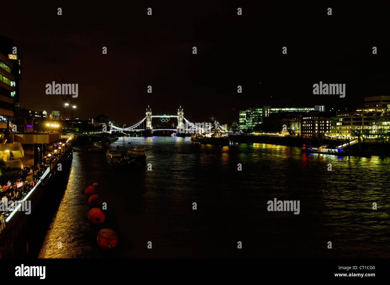 LONDON, UK - JULY 5, 2012: Olympic rings suspended on Tower Bridge in London, night photography. Stock Photo