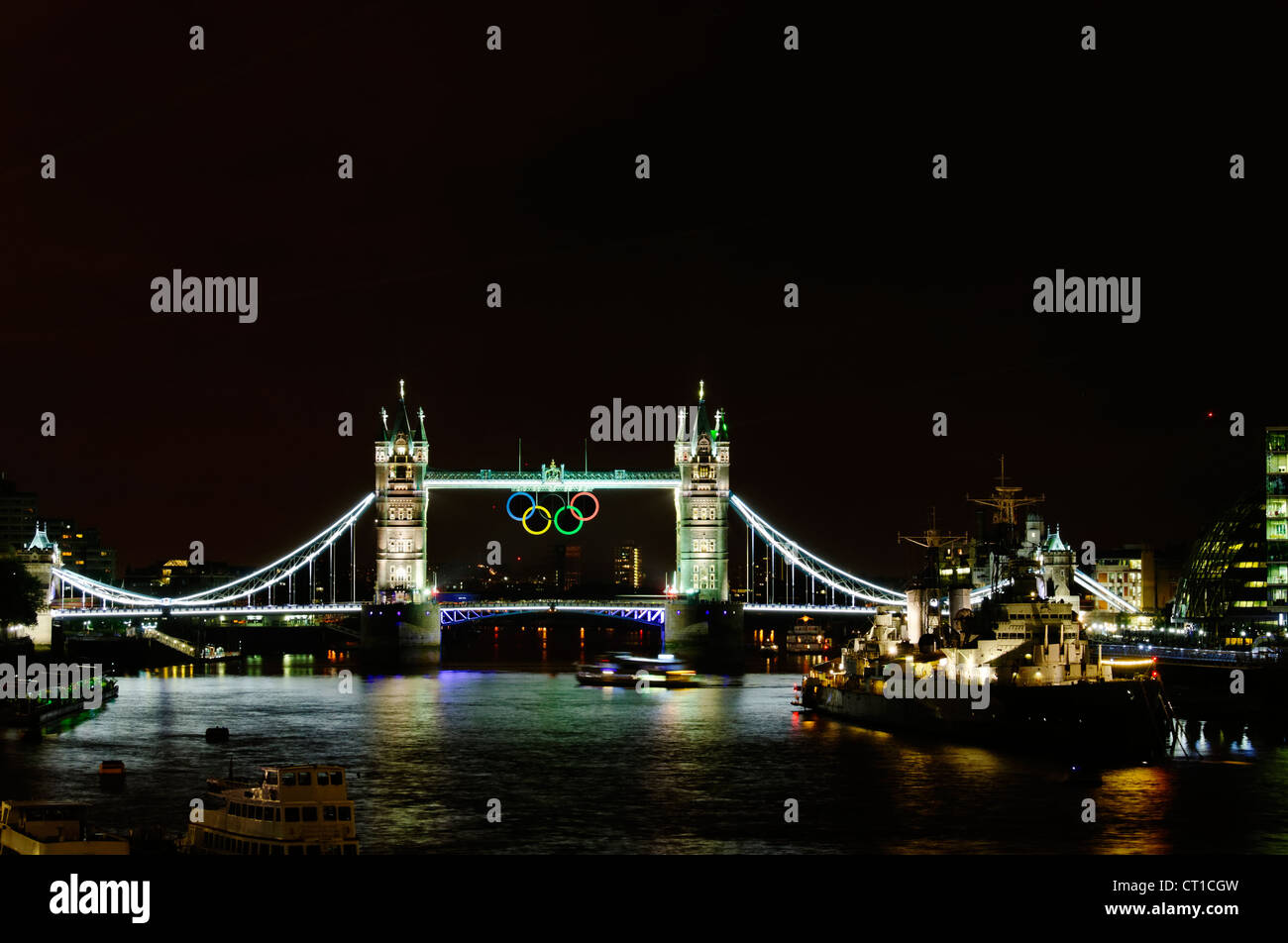 LONDON, UK - JULY 5, 2012: Olympic rings suspended on Tower Bridge in London, night photography. Stock Photo
