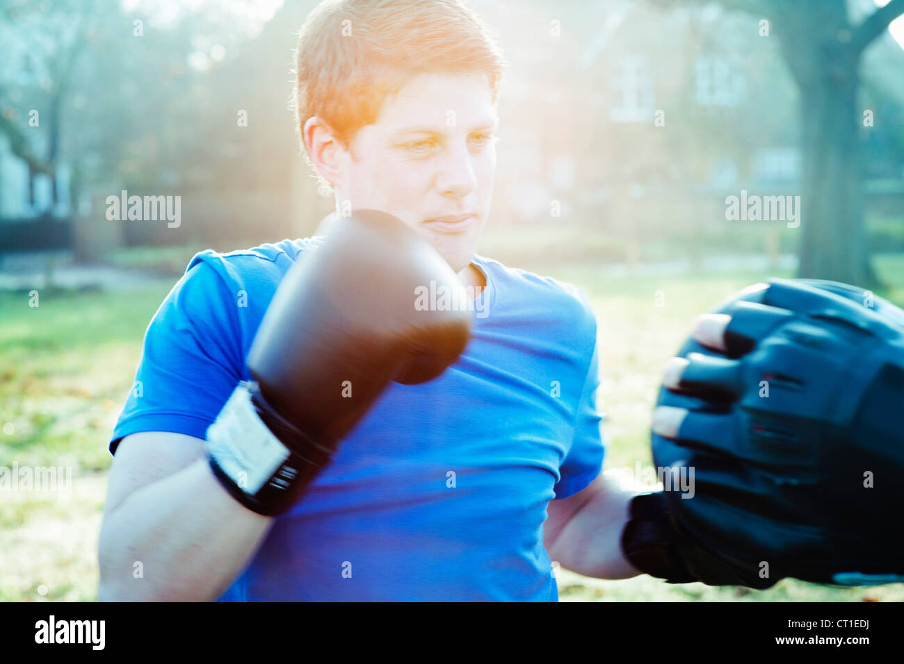 Boxer training with coach outdoors Stock Photo