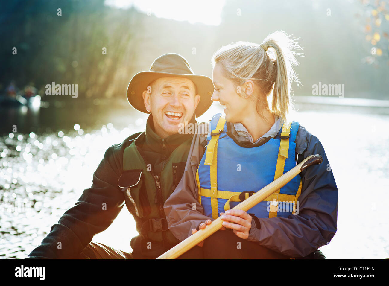 Couple sitting in canoe together Stock Photo