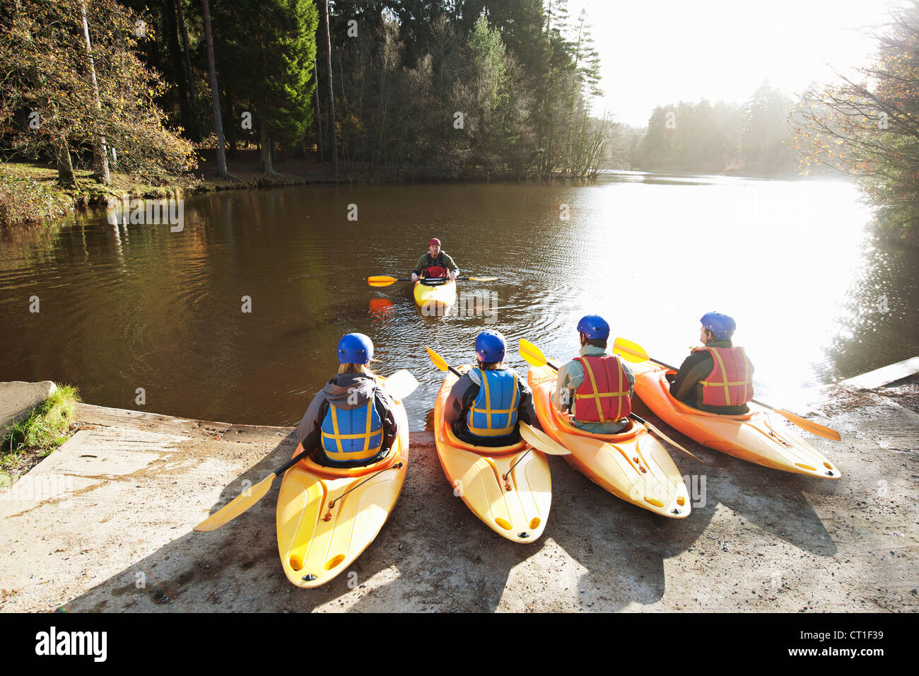 Kayaks lined up at edge of lake Stock Photo Alamy