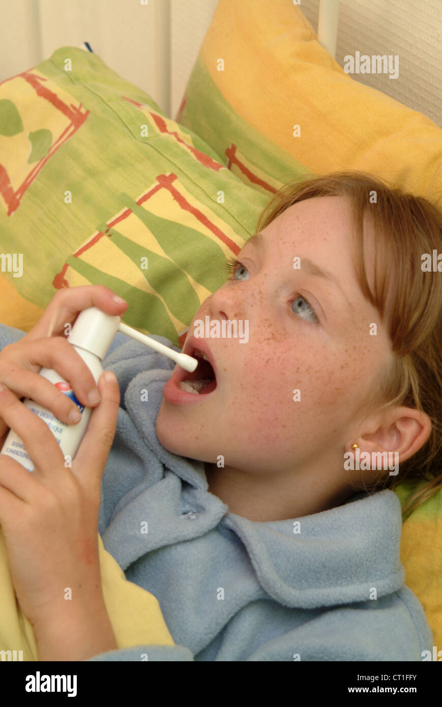 CHILD USING SPRAY IN MOUTH Stock Photo Alamy