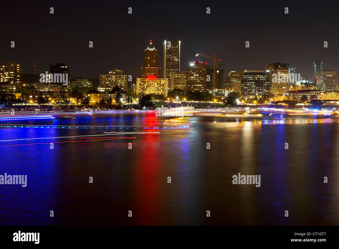 Boat Lights Trails Along Willamette River the City Skyline of Portland Oregon Waterfront at Night Stock Photo
