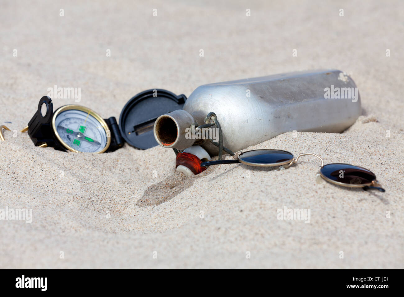 With a compass and a water canteen in the desert Stock Photo Alamy