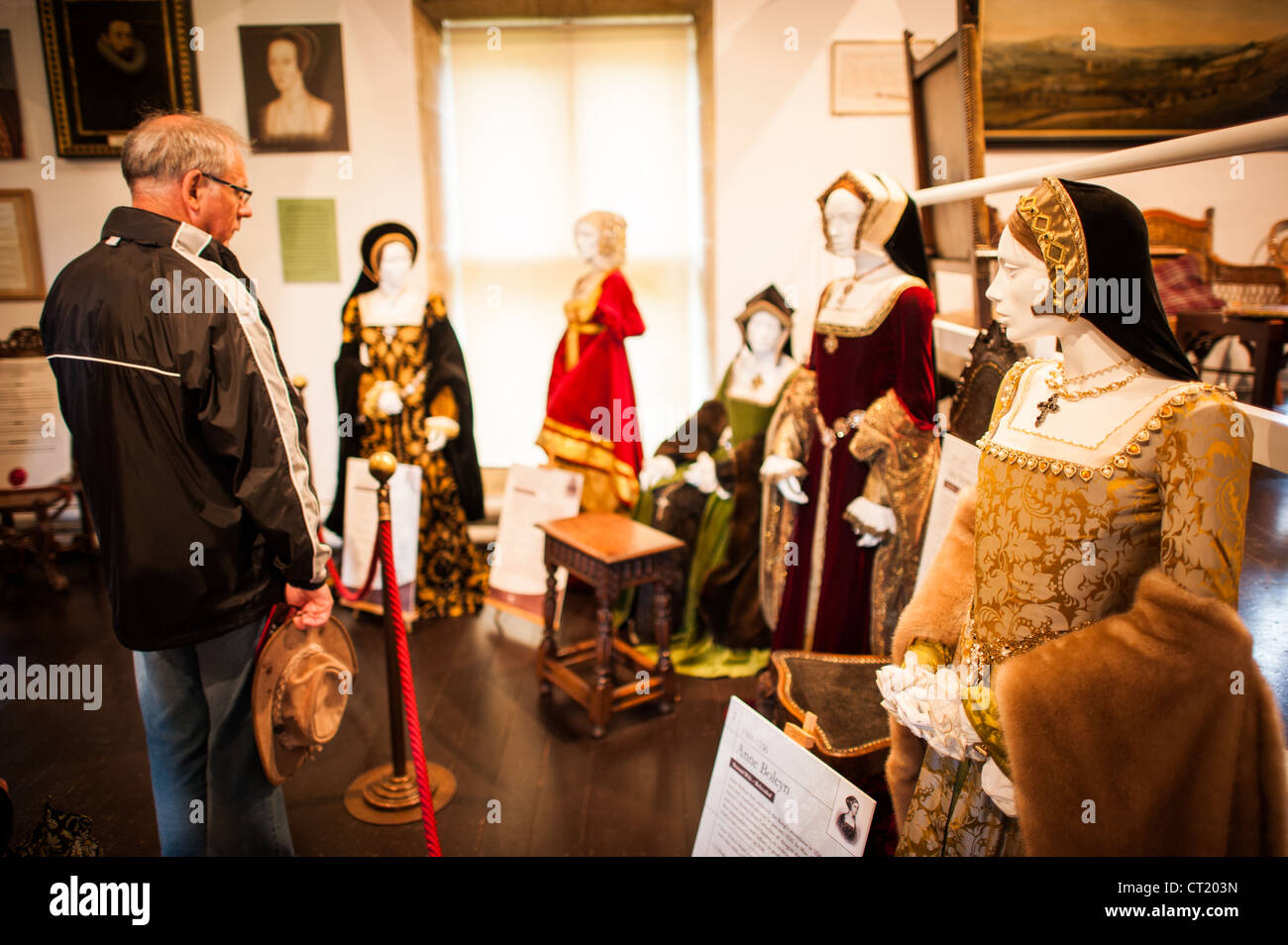 WINCHCOMBE, England — An exhibit at Sudeley Castle in Gloucestershire featuring period costumes representing Henry VIII's six wives. The display includes detailed Tudor-era clothing, with Anne Boleyn's figure visible at the far right. This educational installation at Catherine Parr's final home offers visitors a tangible connection to Tudor history and the dramatic story of Henry VIII's marriages. Stock Photo