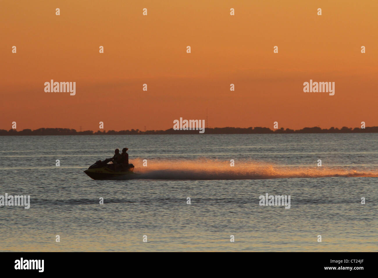 Man and Woman on Jet Ski and Lake Erie Sunset. From Catawba Island