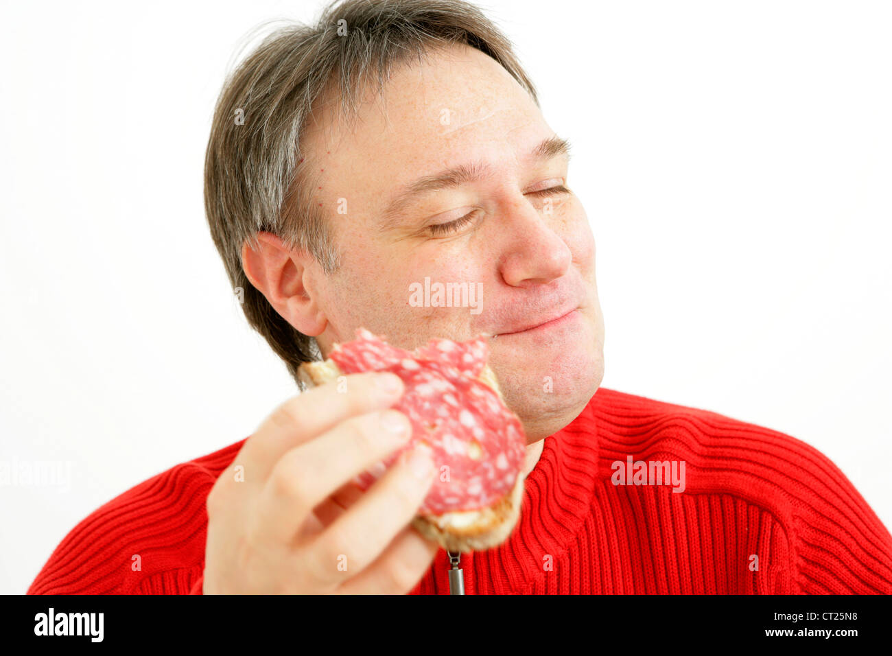 MAN EATING PORK MEAT Stock Photo Alamy
